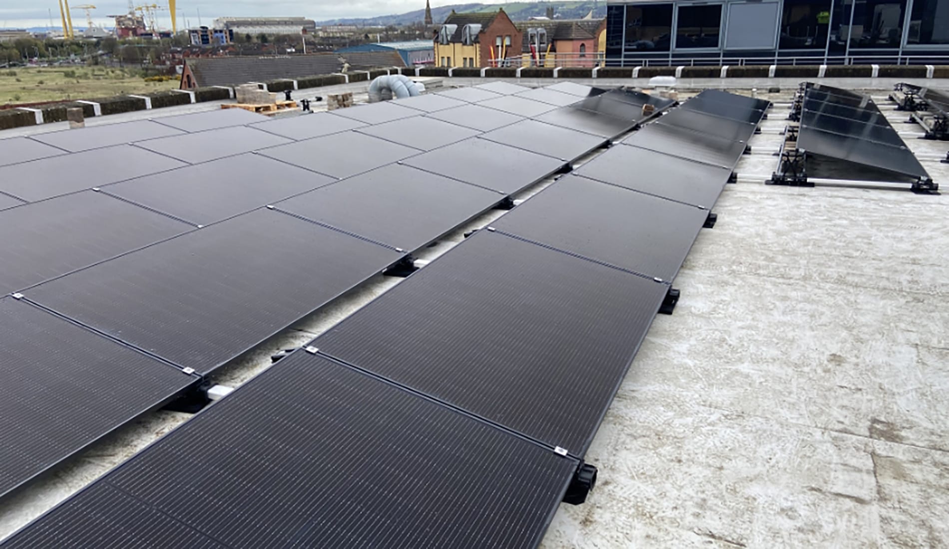 Close-up of man working on Solar PV roof