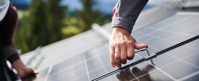 Close-up of man working on Solar PV roof