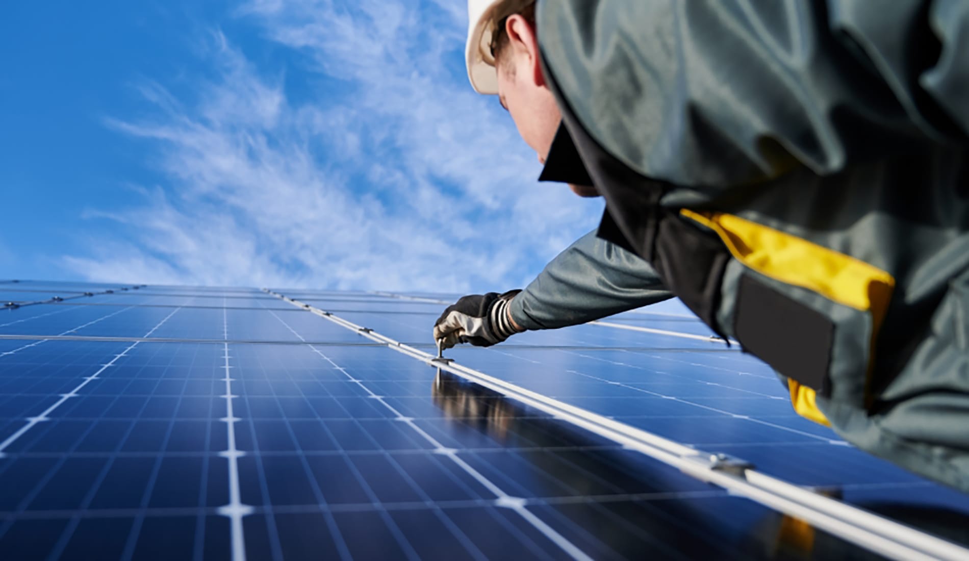 Man working on solar PV panel