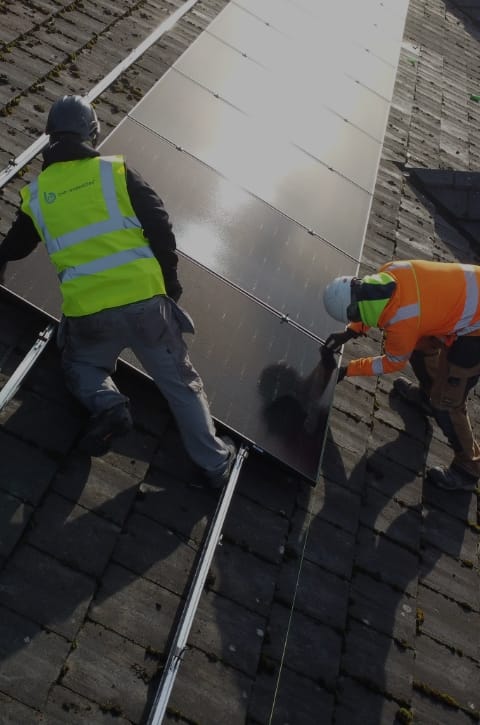 dunsilly workers putting solar panels on building